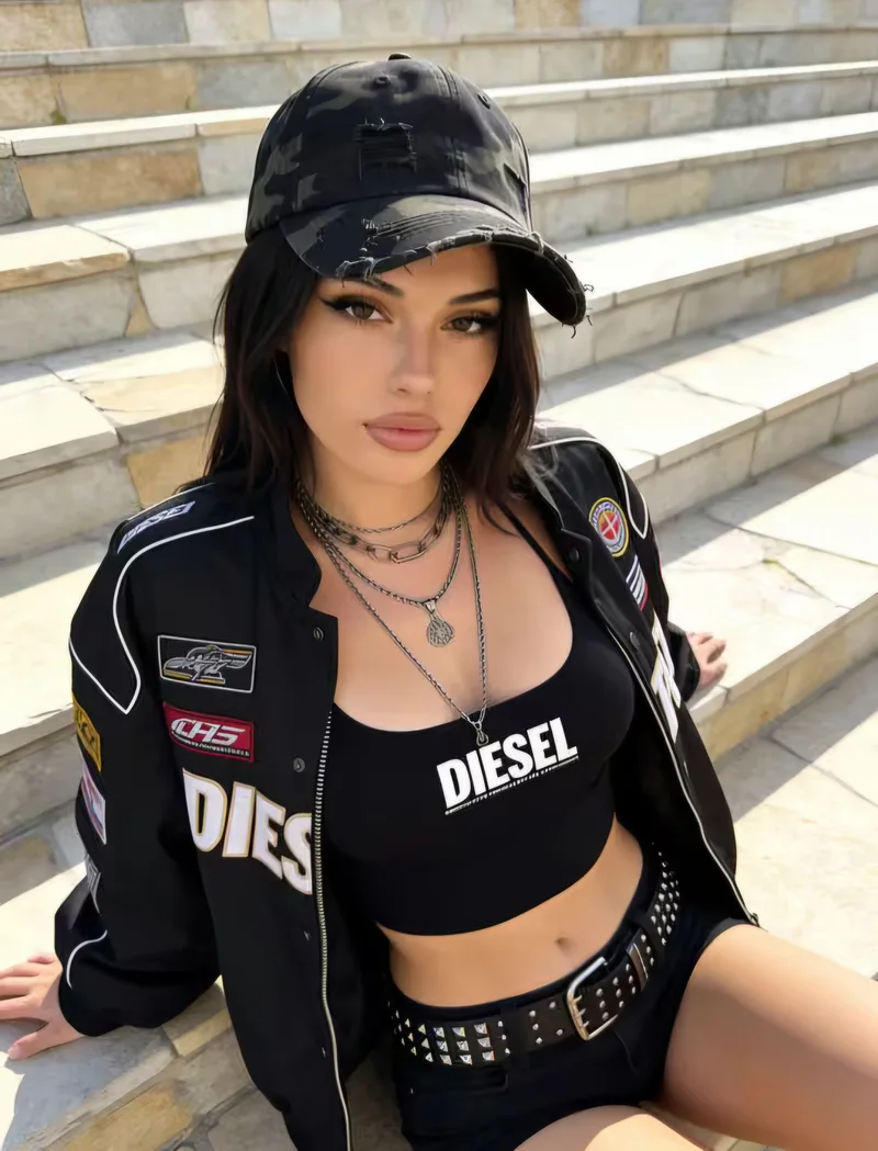 Adult woman in a black motorcycle jacket seated on stone steps
